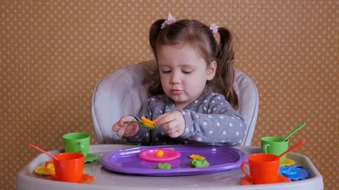 Small girl playing with soft modeling colored dough Stock Footage 103790281
