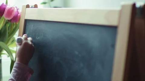 Small girl practicing simple math on chalk board Stock Footage 35252685