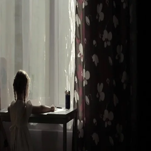 Small girl put a picture from table to wall Stock Footage 69700517