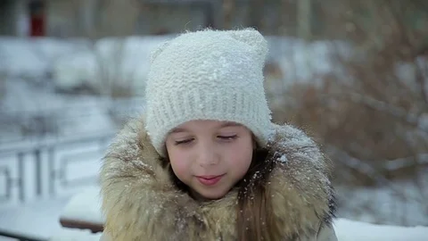 Small girl snowfall slow motion Stock Footage 73354859