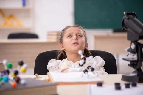 Small girl studying in the classroom Stock Photos