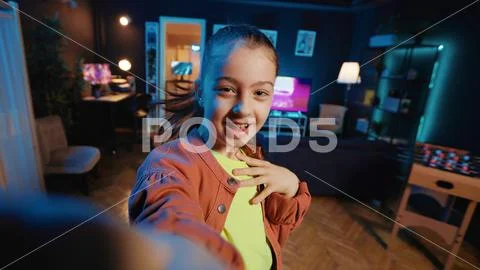 Small girl taking part in viral dance craze, filming POV style video