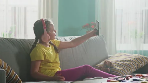 Small Girl Is Using Mobile Phone to Entertain Stock Footage 149109975