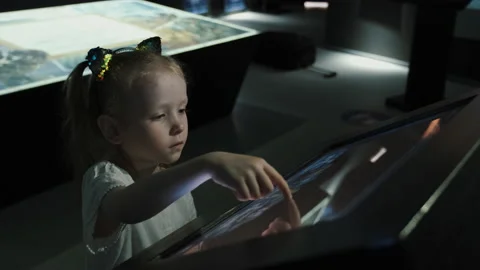 Small girl is using smart interactive screen with touchpad. Modern education Stock Footage 141685862
