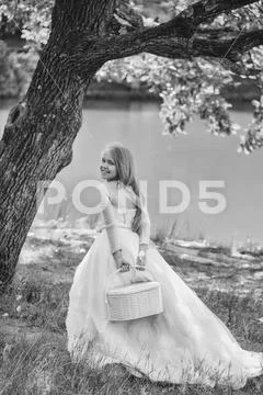Small girl in white dress outdoor Stock Photos