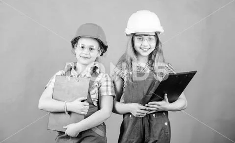 Small girls repairing together in workshop. Future profession. Builder engineer Stock Photos