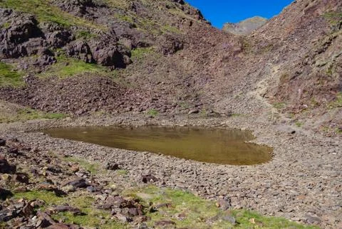 Small glacial lake surrounded by rocks in Coma Pedrosa in Andorra Stock Photos