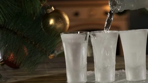 Small glasses stand in row, vodka, tequila, alcohol, camera on rail, New Year Stock Footage 117170219
