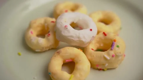 Small glazed mini donuts with colorful sprinkles. Stock Footage 336333695