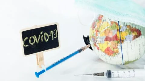 Small globe with  syringe in it. Abstract illness concept. Foto stock