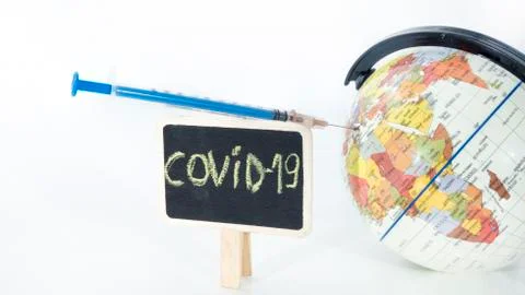 Small globe with  syringe in it. Abstract illness concept. Stock Photos