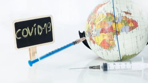 Small globe with  syringe in it. Abstract illness concept. Stock Photos