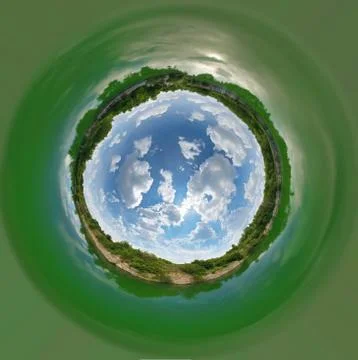 A small globe turned inside out. In the middle of the planet is a blue sky Stock Photos
