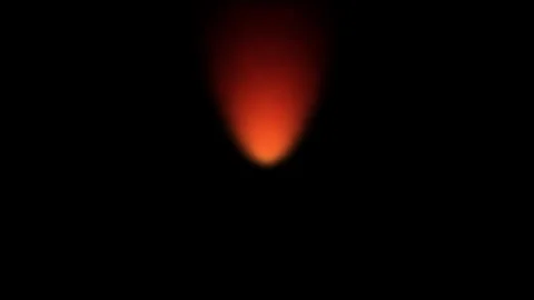 Small glowing embers float upwards against a dark background with cinematic.. Stock Footage 340939968