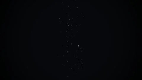 Small glowing particles rise slowly in dark space creating magical cosmic d.. Stock Footage 345572748