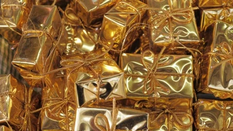 Small gold gift boxes, close-up. For decorating Christmas trees and gifts. New Stock Footage 305749576