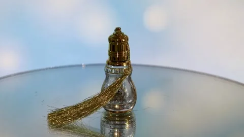 Small gold perfume bottle spinning slowly Stock Footage 338160912