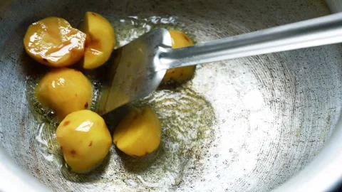 Small golden potatoes frying in a pan, Close-up of small golden potatoes fr.. Video stock 346462909