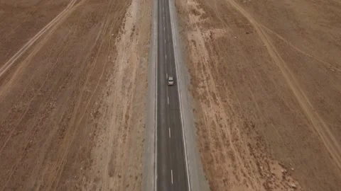 Small gray car driving along straight asphalt road Vídeo Stock 221102094