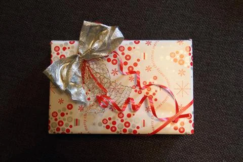 A small gray gift box on black background Stock Photos