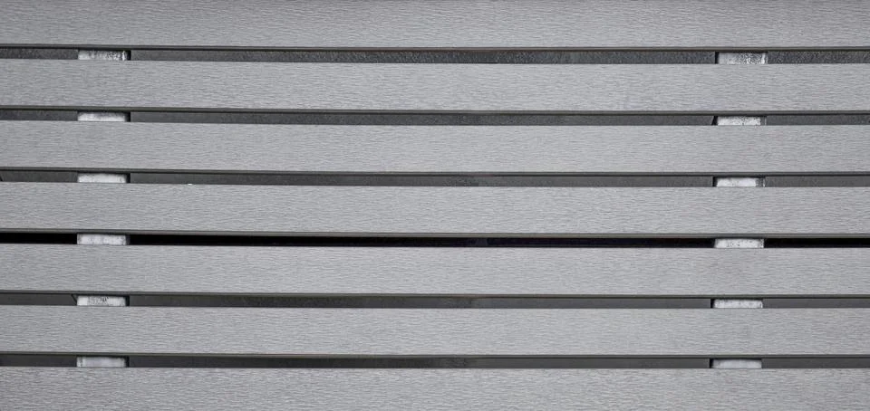 Small gray plaster design background next to horizontal steel Stock Photos