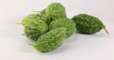 Small green bitter gourd vegetable fruit on white background bamboo basket Stock Footage 266212445