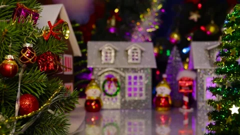 A small green Christmas tree spins in the center of the town Stock Footage 320099596