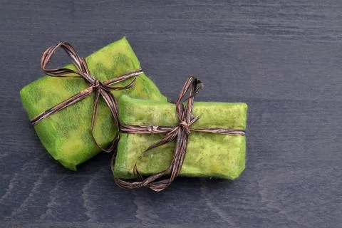 Small green gift boxes with brown ribbon Stock Photos