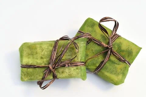 Small green gift boxes with brown ribbon Фото