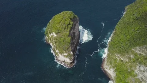 Small green island with the deep blue waves aerial footage Stock Footage 101665571