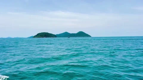 Small green islands standing out in the middle of the deep blue waters Stock Footage 327734491