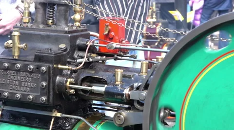 Small green steam engine close up people passing by Stock Footage 63204706