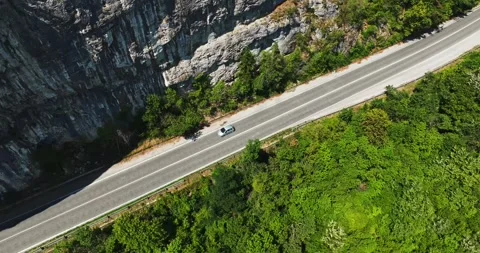 Small Grey Car Approaching Man Made Carving Tunnel Birds Eye Tracking Panning Stock Footage 300444313