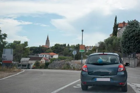 Small grey hatchback standing on an intersection in the town of Selca, small  Stock Photos