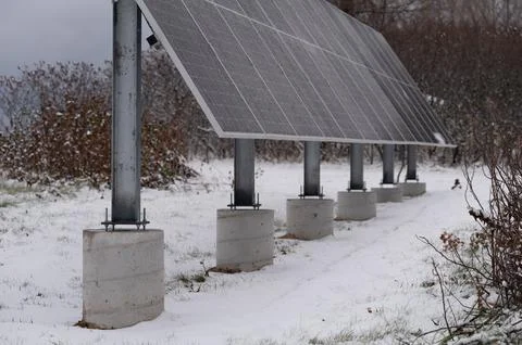 Small ground array of solar panels in snow Stock Photos