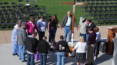 Small Group of Adults Praying in Circle Around a Cross Outside Stock Footage 45361494
