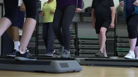 Small group of people doing step aerobics 動画素材 83412888