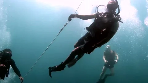 Small Group Of Scuba Divers Underwater Video stock 130360470