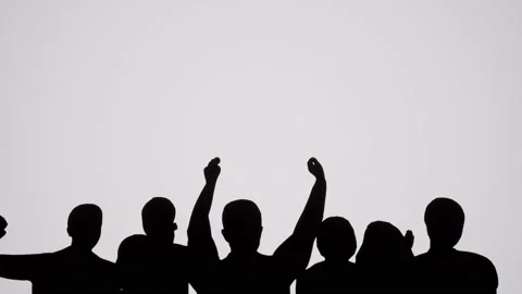 A Small group of silhouetted people cheering Video stock 155224334