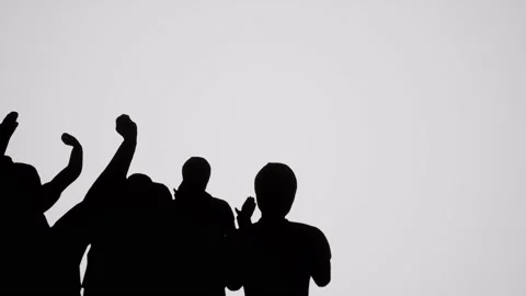 A Small group of silhouetted people watching and cheering Stock Footage 155302000