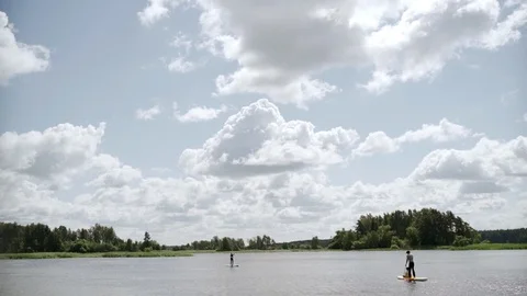 Small group stand up paddle boarding on SUP board slow motion video. Stock Footage 112165176