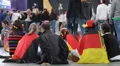 Small Group Supporters of German Football Team Sitting Waiting for Semifinals HD Footage