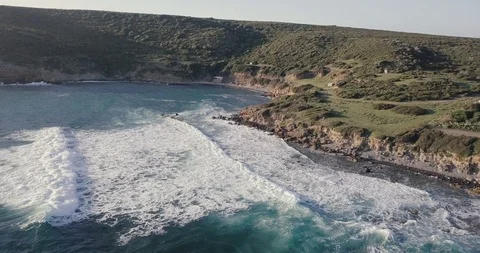 A small group of surfers paddling for waves in wetsuits Stock Footage 112053386