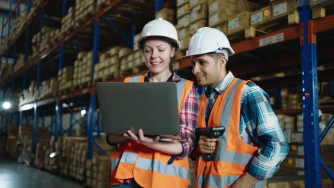 A small group of warehouse workers making a short meeting in distribution center Stock Footage 163348448