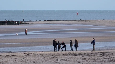 Small groups of people on the beach winter Stock Footage 91824927