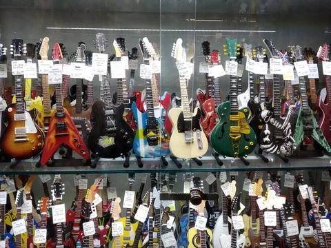 Small guitars in the shop window Stock Photos