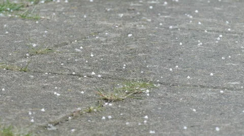 Small hail grains fall on the terrace Video stock 62683905
