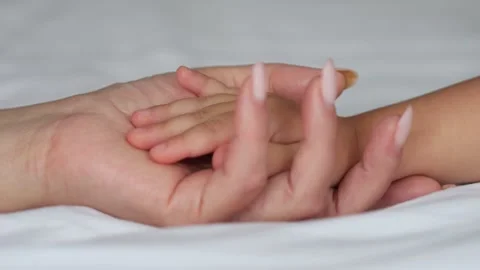Small hand of child gently lands in mother open palm with trust Stock Footage 301385002