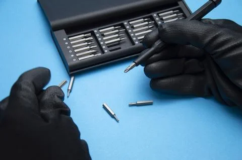 Small hand screwdriver with interchangeable tips, screwdriver for DIY work. Stock Photos