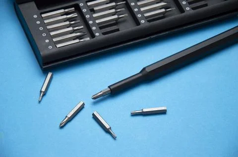 Small hand screwdriver with interchangeable tips, screwdriver for DIY work. Stock Photos